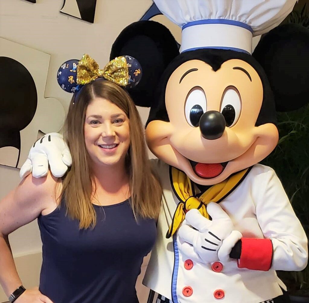 Erin MacDonald-Behrend posing with Mickey Mouse
